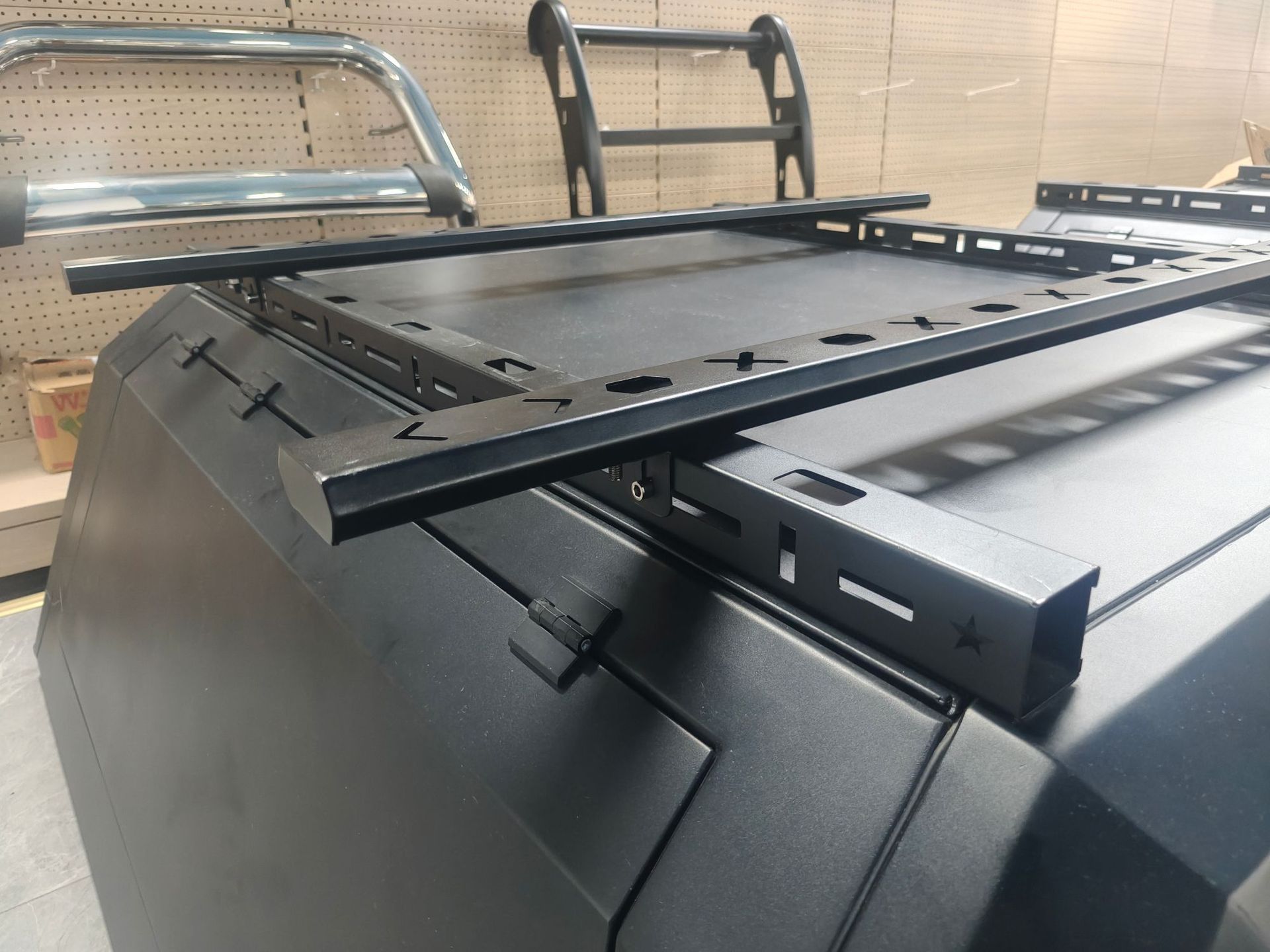 Specialized black metal roof rack for pickup truck bed modification with guardrail protection design