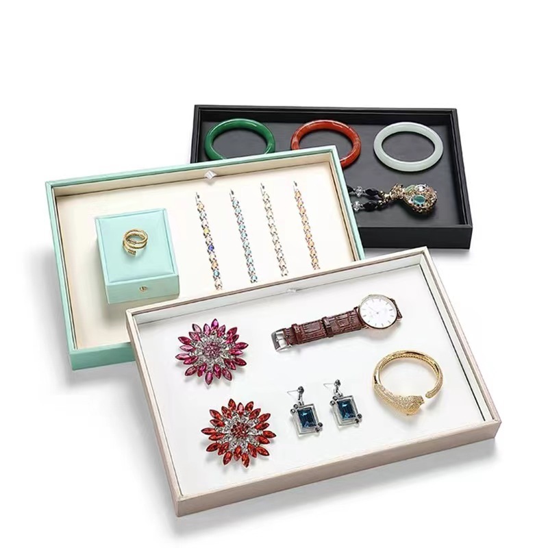 Spindle-shape jewelry organizer for rings, necklaces, bracelets, pendants, and accessories; storage tray for gold and other jewelry items.