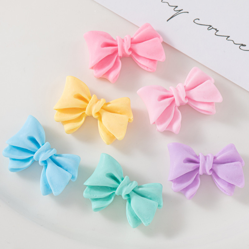 Accesorios de resina de arco de color macaron DIY Crema Accesorios de cuerda de cabello de agujero de caja de teléfono móvil Colgante de hebilla de zapato