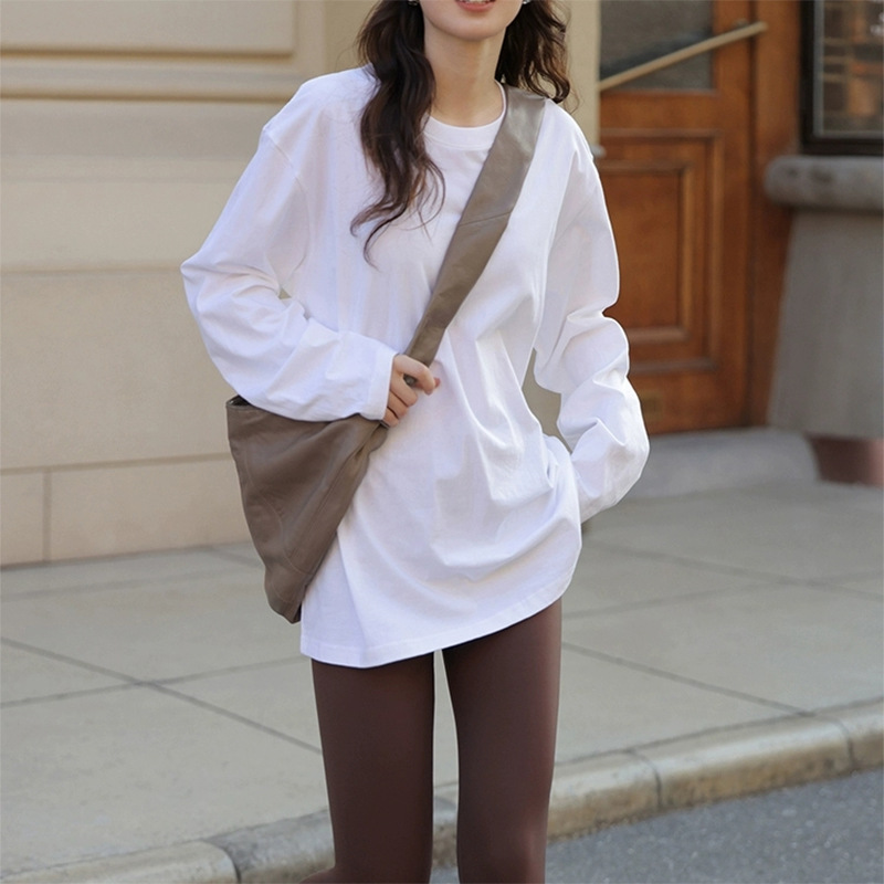 Women's long-sleeved base layer top paired with sharkskin pants, layered over a loose-fitting, pure cotton white long-sleeved t-shirt that covers the hips.