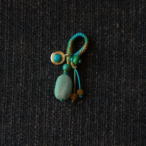 Genuine design pendant with tassels