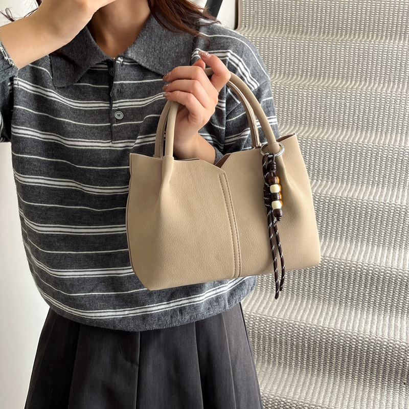 Bolso de mano de alta sensación de moda bolso de balde de mujer 2025 invierno retro simple bolso de hombro temperamento mochila de viaje