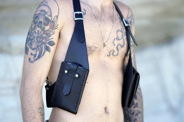 Black mobile phone, underarm bag
