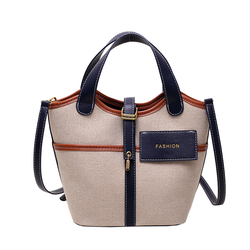 Bolso de lona para mujer 2026, nuevo diseño de nicho, bolso de mano tipo cubo, bolso retro de moda, bolso de hombro cruzado tipo cesta