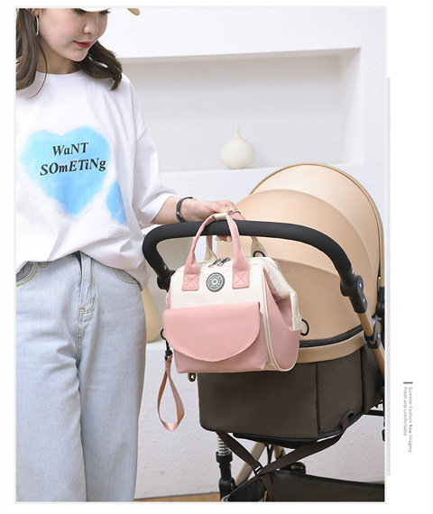 The Mommy bag is small and cute. It has a detachable front pocket and is a multi-functional baby bag. It is waterproof, lightweight, and has a crossbody design. It can be used to carry milk bags undefined