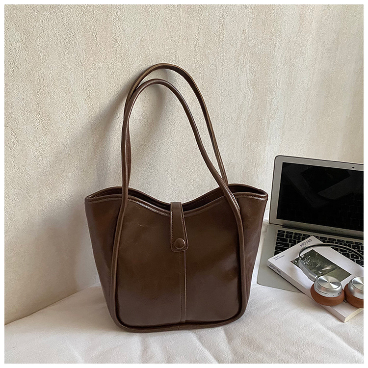 Este año, la moda simple bolso de cubo de mujer venta caliente nueva textura de alta calidad retro versátil lujo ligero bolso de hombro