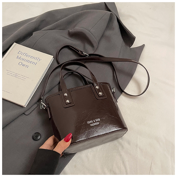 2025 nuevo nicho de moda bolso de cubo de mano para mujeres estilo coreano simple versátil bolso de hombro de moda mochila casual