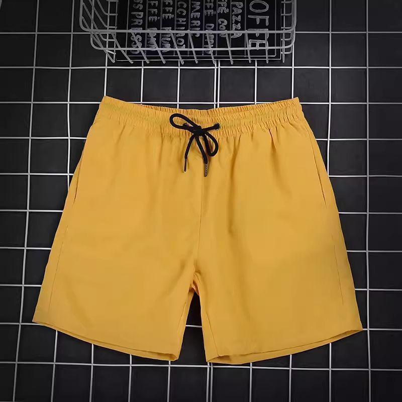 Pantalones de cuatro puntos Pantalones cortos casuales de verano para hombres Pantalones de playa de color caramelo para hombres de moda Pantalones de tres puntos deportivos sueltos de secado rápido
