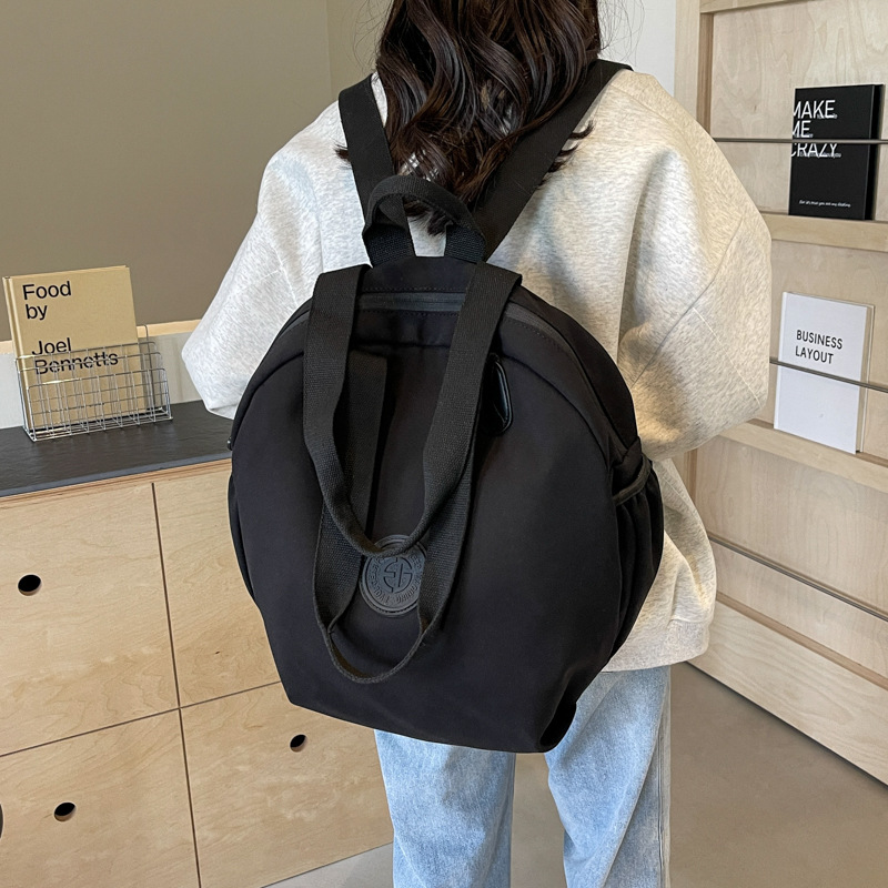 Small shoulder bag, one‑shoulder backpack style, round design, black