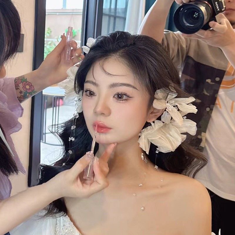 Bridal headpiece with a forest-inspired, high-end, ethereal feel, featuring tassels and flowers, made of delicate silk, suitable for wedding and bridal makeup accessories