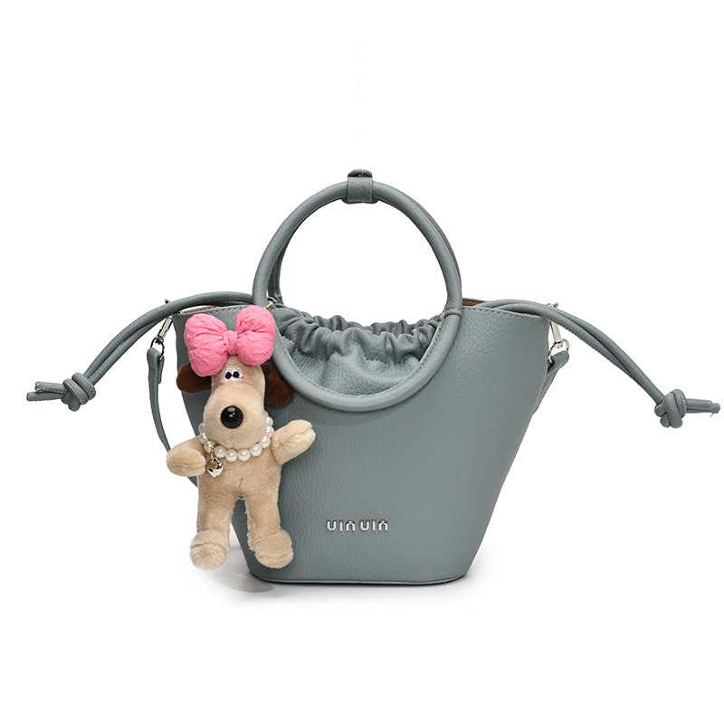 Bolsos de mano de nicho de tendencia transfronteriza para damas 2025 nuevo bolso de hombro simple de moda con textura bolso de cubo de todo fósforo