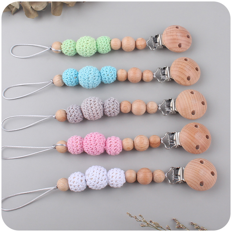 Nuevo bebé suministros Beech Rattle teether juguete calmante bebé bola de lana cuentas de madera pezón cadena traje
