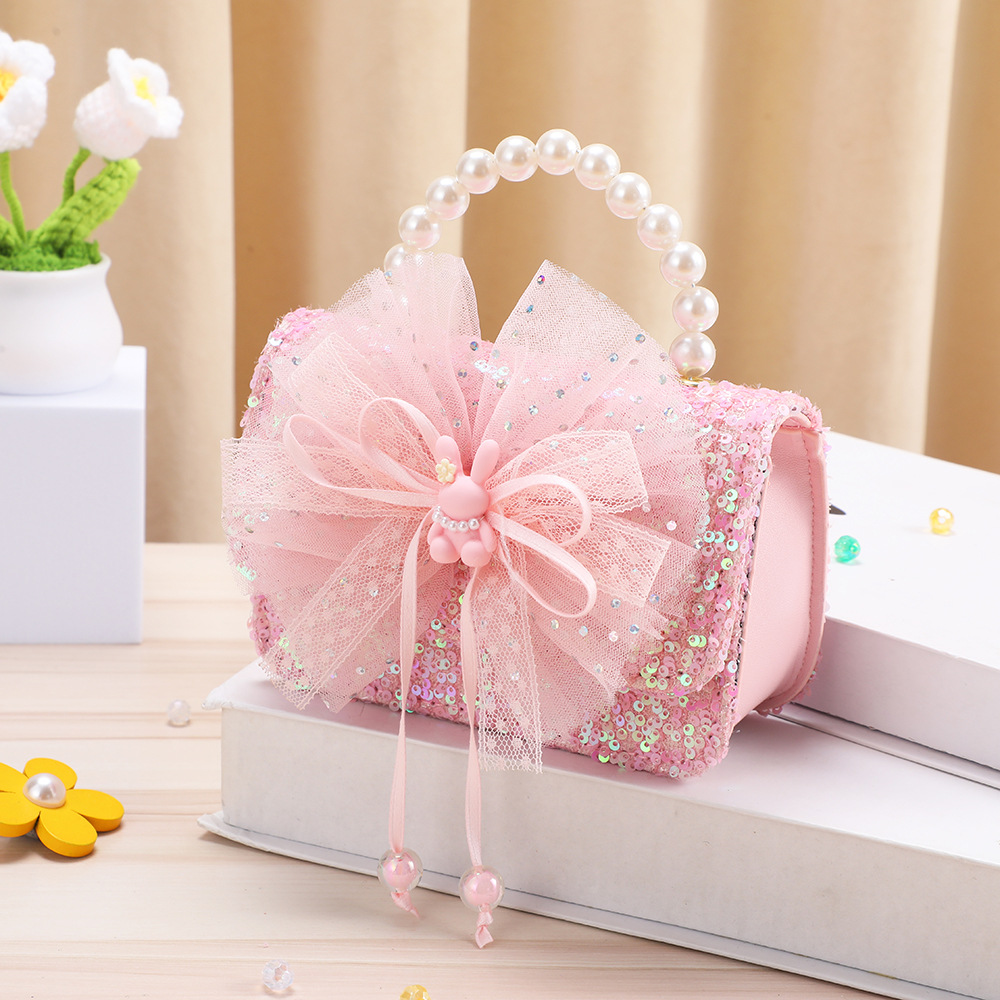 Monedero infantil con lazo, mochila pequeña, bolso bandolera de dibujos animados My Melody para niña, lentejuelas que reducen el peso