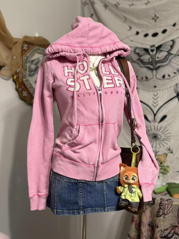 Hollister-style sweet girl pink hooded sweatshirt for women, with a slimming, waist-cinching, zip-up design, and a casual outerwear look Hollister-style sweet girl pink hooded sweatshirt for women, with a slimming, waist-cinching, zip-up design, and a casual outerwear look
