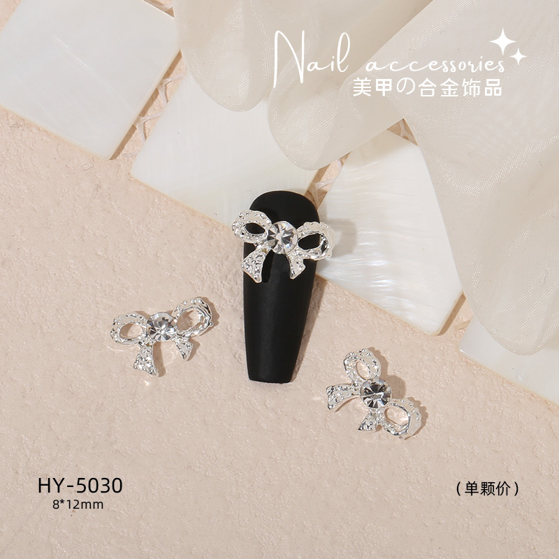 Nuevo arco de uñas amor aleación decoración de uñas flor de la luna mariposa clavo taladro fábrica joyería al por mayor