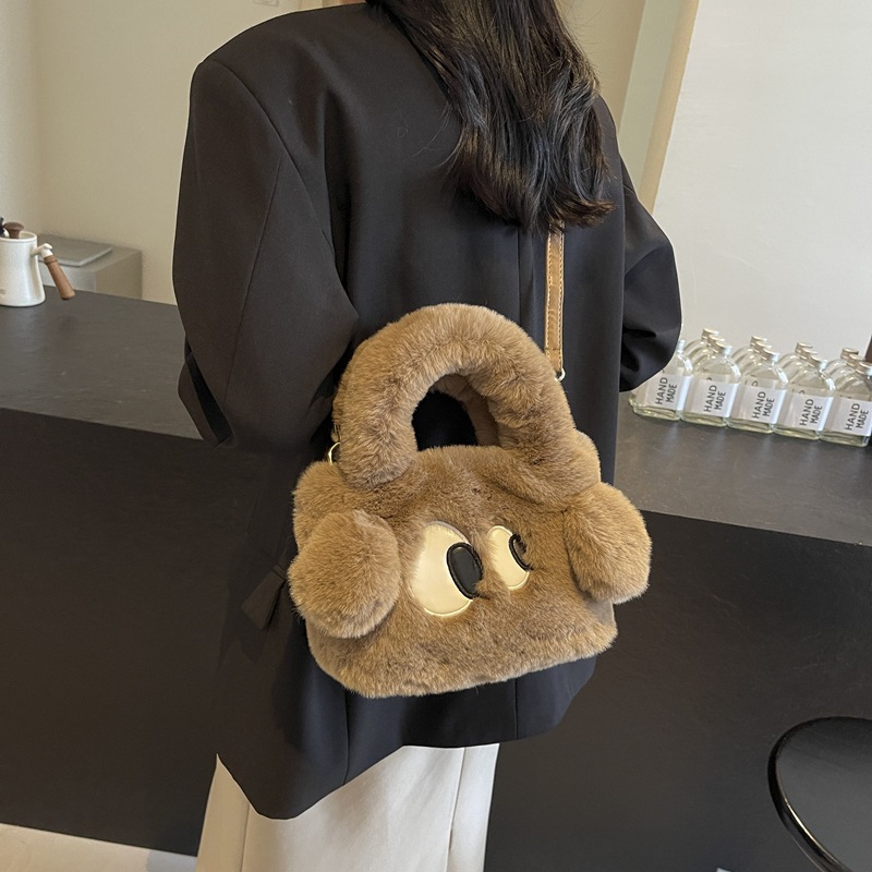 Bolsa de cubo de pelúcia de ojos grandes perros mujeres otoño y invierno 2025 nuevo tipo de bolso de hombro, bolso de mochila encantador