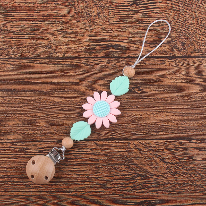 Nuevos suministros para bebés clip de chupete de haya calmante bebé girasol mordedura de silicona chupete cadena anti-caída de la cadena