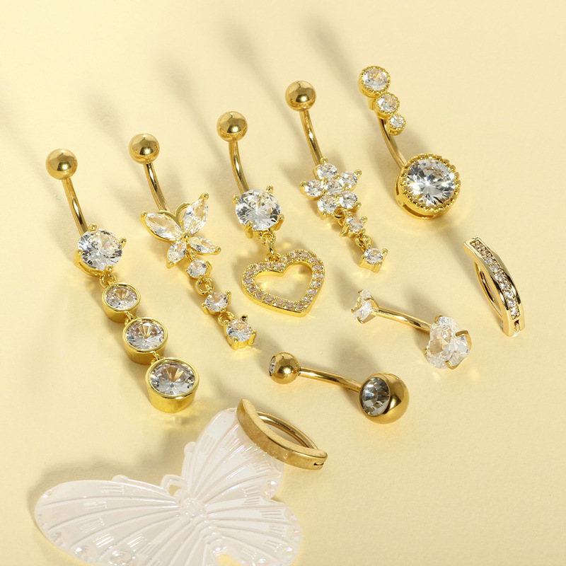 9つのステンレスのへその輪の組み合わせの銅はジルコンの水滴のへその輪の円形のハート型のへその釘のメーカーの現物を入れます。