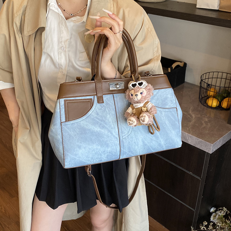 Bolso de mano retro de otoño y invierno para mujeres 2025 nuevo estilo de alta calidad de la bolsa de transporte de viaje empalmado bolso de hombro