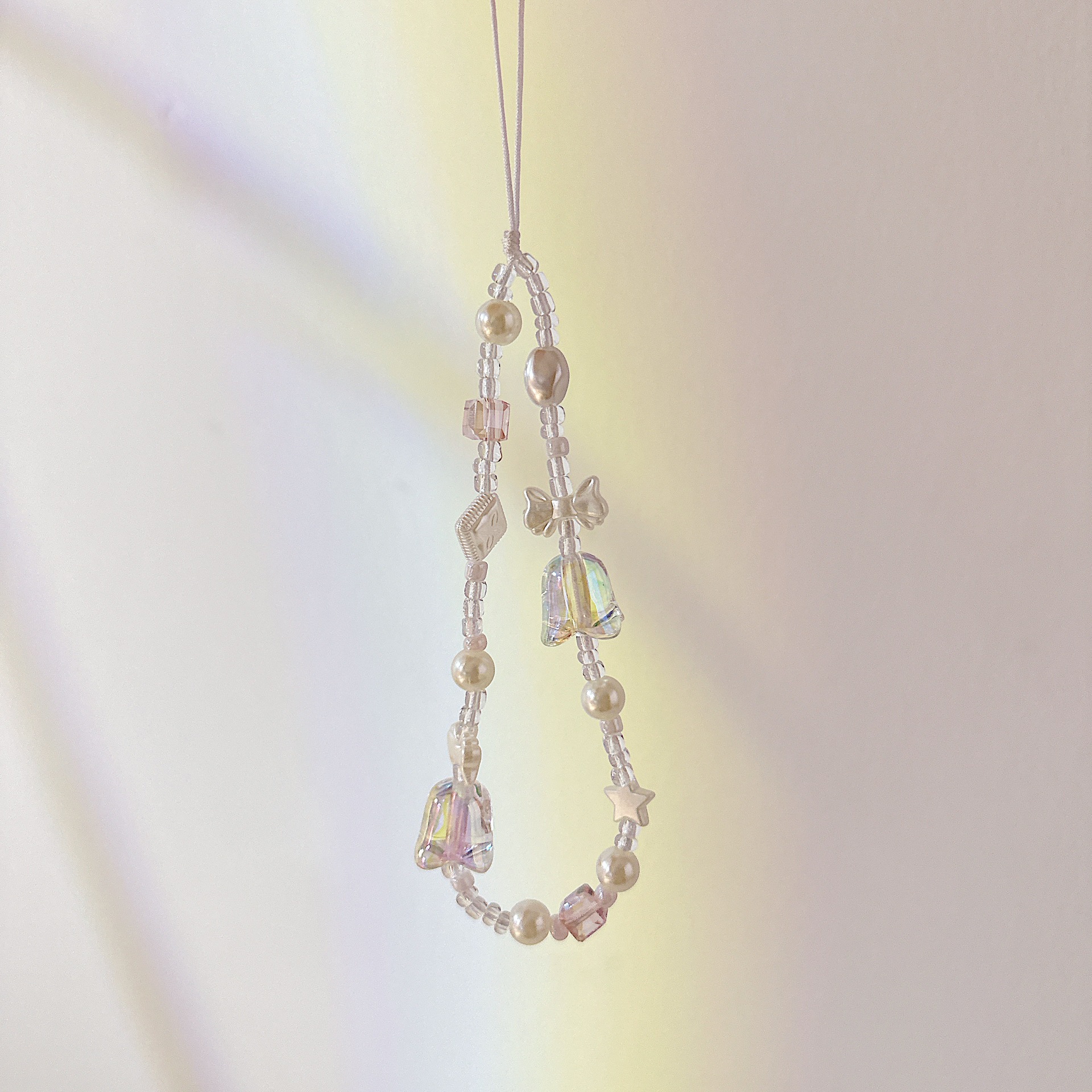 Aplicable cadena coreana orquídea de campana cadena de muñeca arco cuentas de caso de teléfono móvil colgante anti-perdida colgar pulsera trenzada