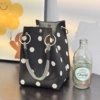 Ring buckle bag with black background and rice dots