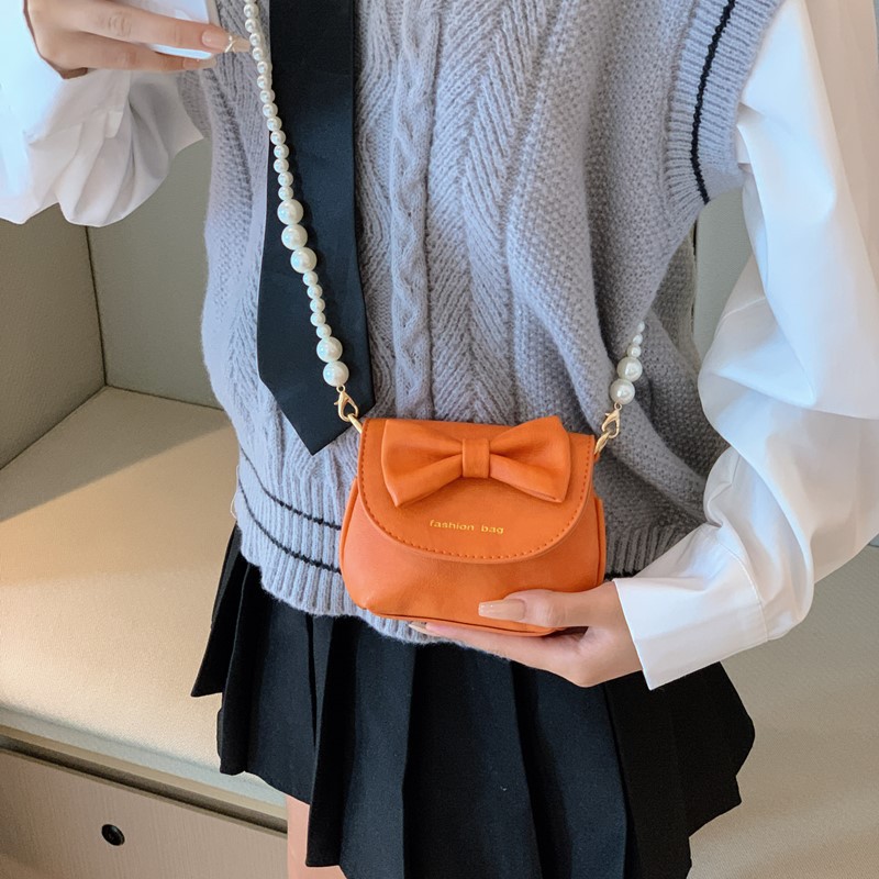 Cute mini niñas bolso de hombro dulce perla bolso de bebé coreano nuevo bolso de cambio de color sólido para niños