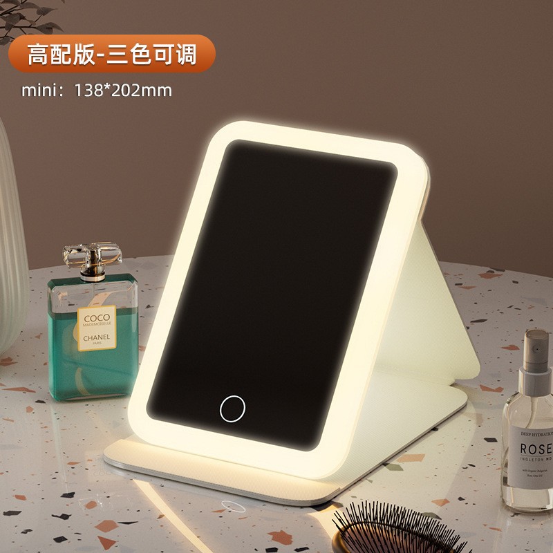 Espejo de maquillaje LED espejo de belleza plegable espejo de maquillaje de escritorio carga con luz de tres colores espejo de relleno de luz entrega al por mayor