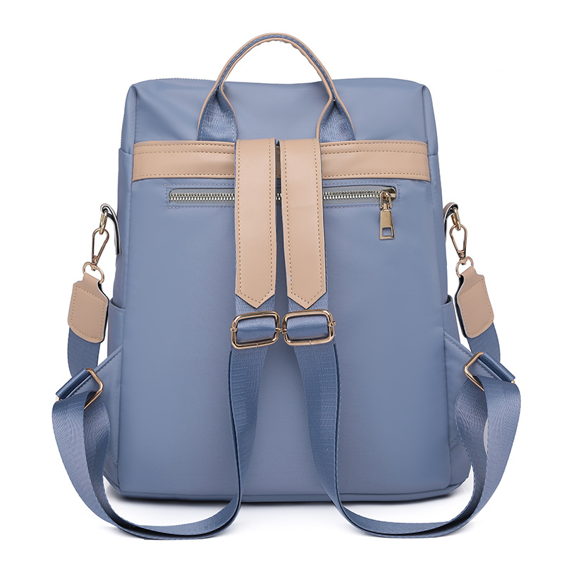 Comercio exterior al por mayor 2023 verano nuevas señoras mochila de nailon moda contraste color borla mochila de viaje de doble uso marea