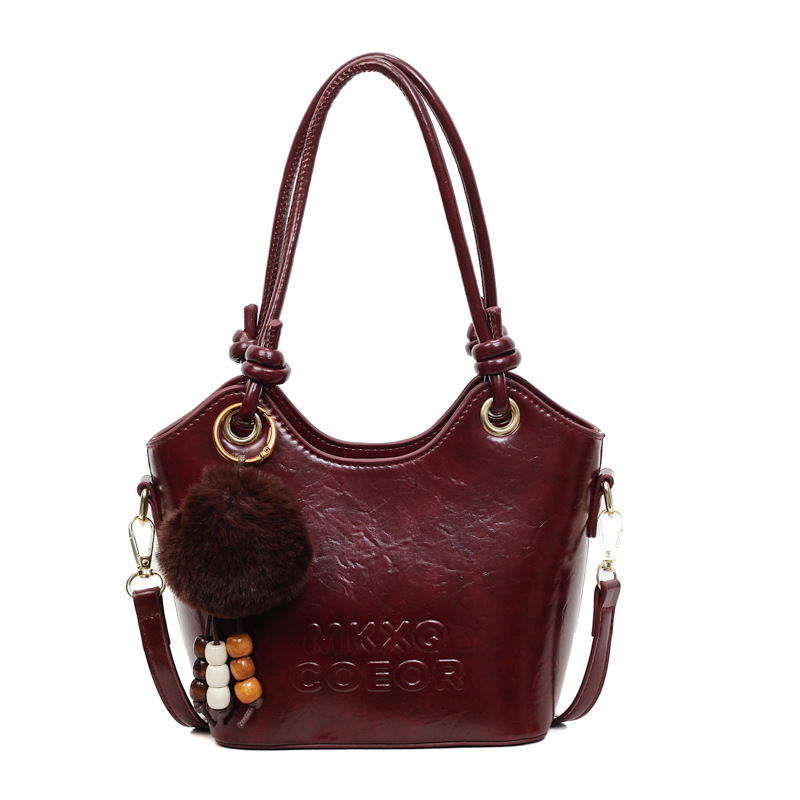 Retro alta sensación de bolso de cubo de mano 2025 invierno nuevo ocio versátil bolso de hombro de viaje mochila de mujer