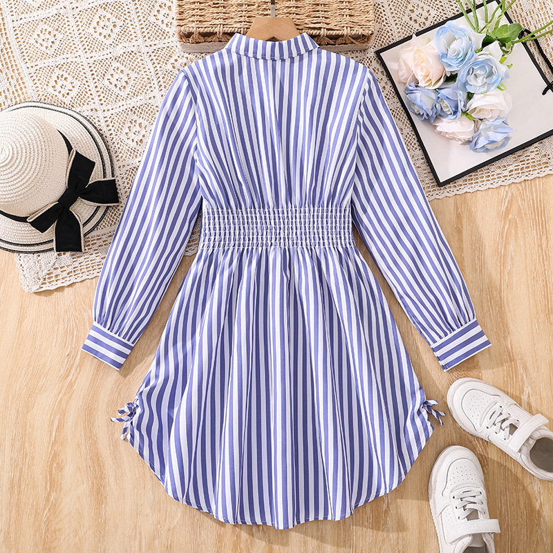 Vestido de niña de comercio exterior 2026 otoño nuevo estilo rayas de niños de tamaño medio y grande de manga larga larga larga laterales de dibujo de la camisa de cintura de falda
