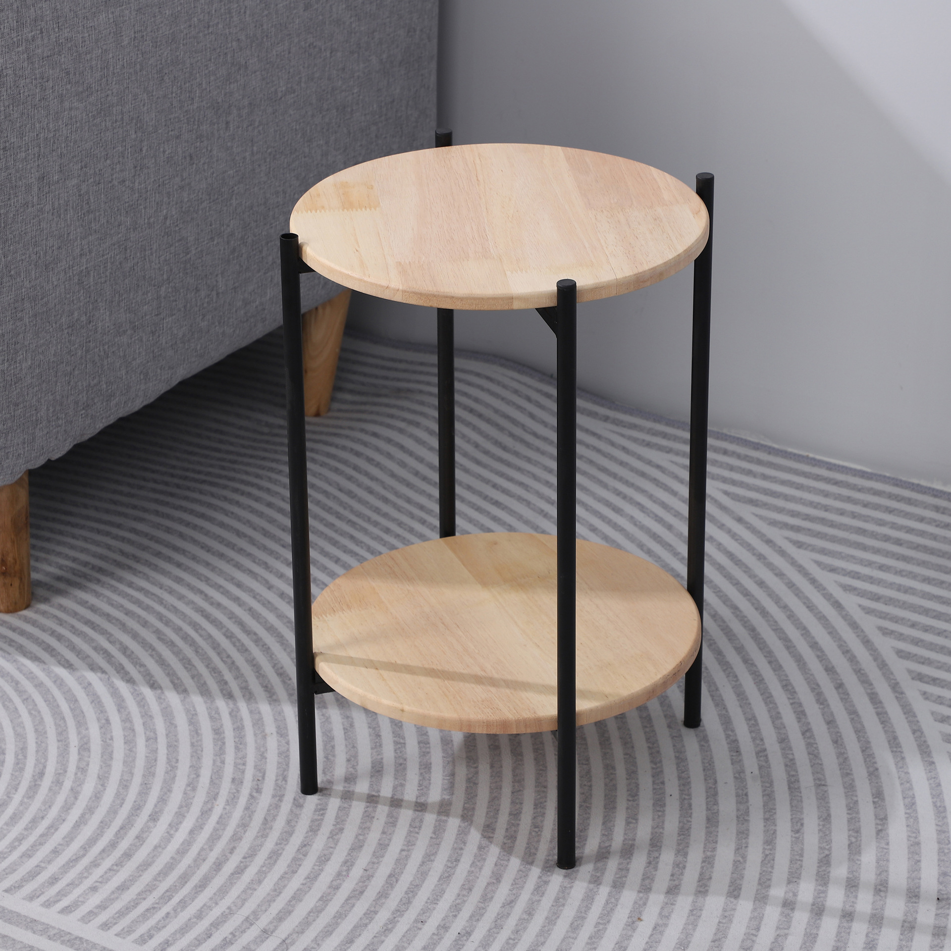 Mesa redonda de doble capa moderna y simple para la sala de estar doméstica con varios objetos de hierro forjado en la esquina de la mesa de ocio del balcón