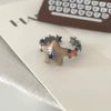 Разноцветная пятиконечная звезда с чёрным фианитом