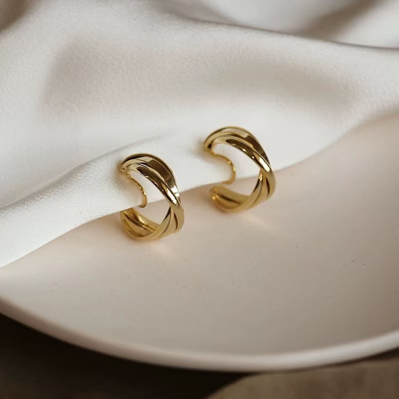 A pair of bright gold mosquito coil ear clips [copper plated with real gold]
