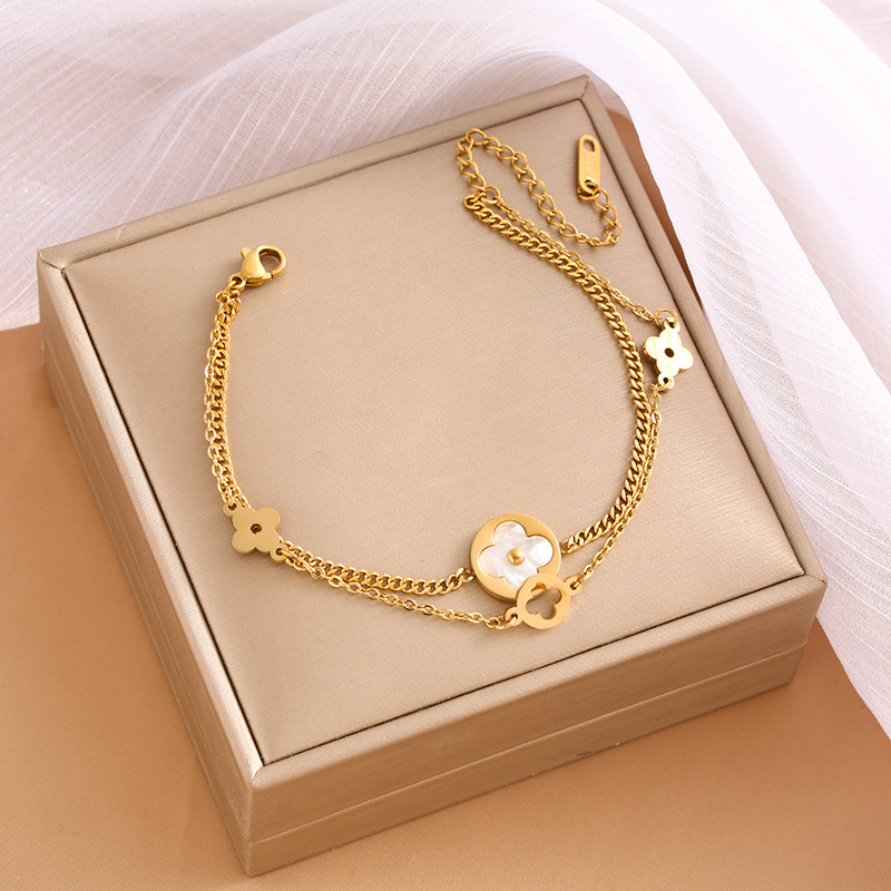 Pulsera de trébol de acero titanium vendedora caliente transfronteriza europea y americana con incrustaciones de concha pulsera colgante pulsera de diseño avanzado sin desvanecimiento al por mayor