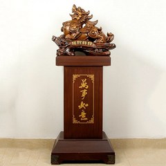 A large resin craft wooden display, featuring a majestic Pixiu seated on a high throne, placed in a company hotel lobby for the grand opening and relocation celebration.