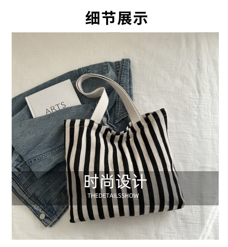 The new cross-border vertical striped commuter tote bag, hand-held shoulder bag, is fashionable and has a large capacity. It features an InS-style simple letter sail undefined