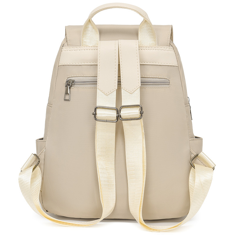 Mochila de color sólido para mujer 2025 moda coreana simple y salvaje mochila de tela Oxford mochila de viaje de ocio para mujer al por mayor