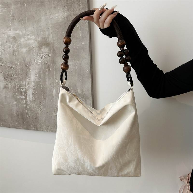 Nueva bolsa de estilo chino para mujeres 2024 verano nuevo estilo simple de moda seda bolso inferior nicho universal bolso de hombro casual