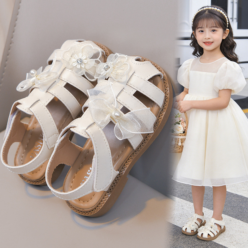Sandálias huecas para niñas 2026 verano nuevo estilo de moda infantil versátil princesa zapatos de playa de arco suave