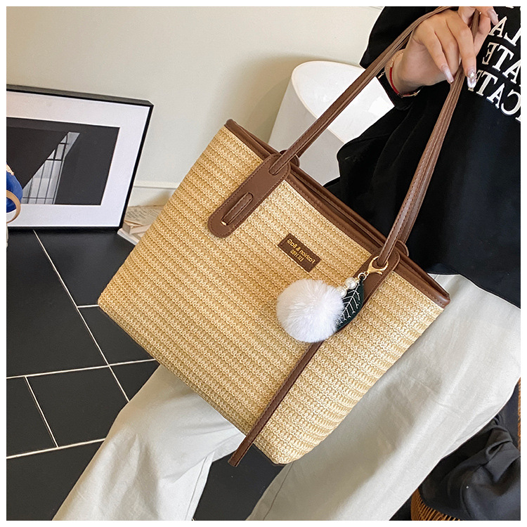 This is a new 2025 summer beach-style women's bag with a simple and versatile hand-held design. It's a single-shoulder vacation woven bag undefined