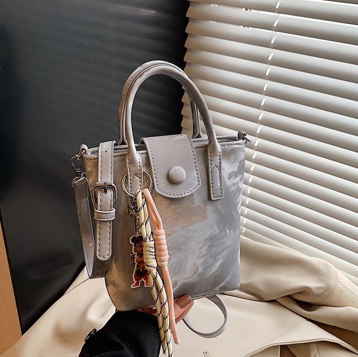 Verano super caliente mini bolso de mano para mujeres 2025 nueva moda bolso de balde de moda explosión de textura universal mochila