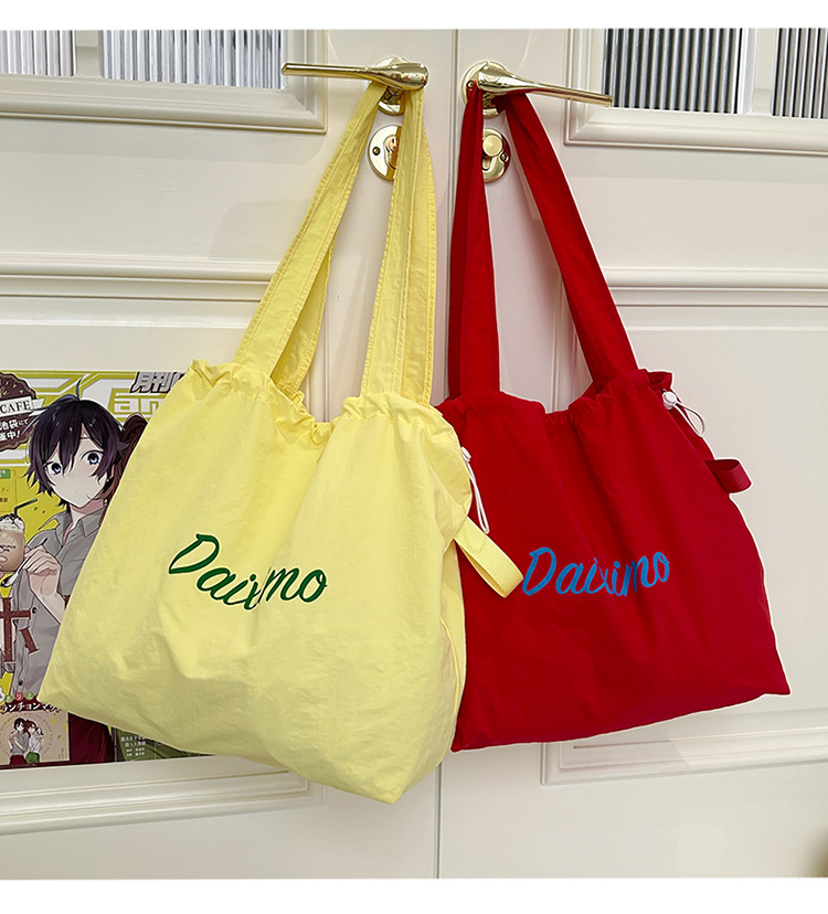 Solid color large-capacity tote bag 2025 bestseller, fashionable commuting lightweight handbag, laid-back style drawstring nylon bag for women undefined