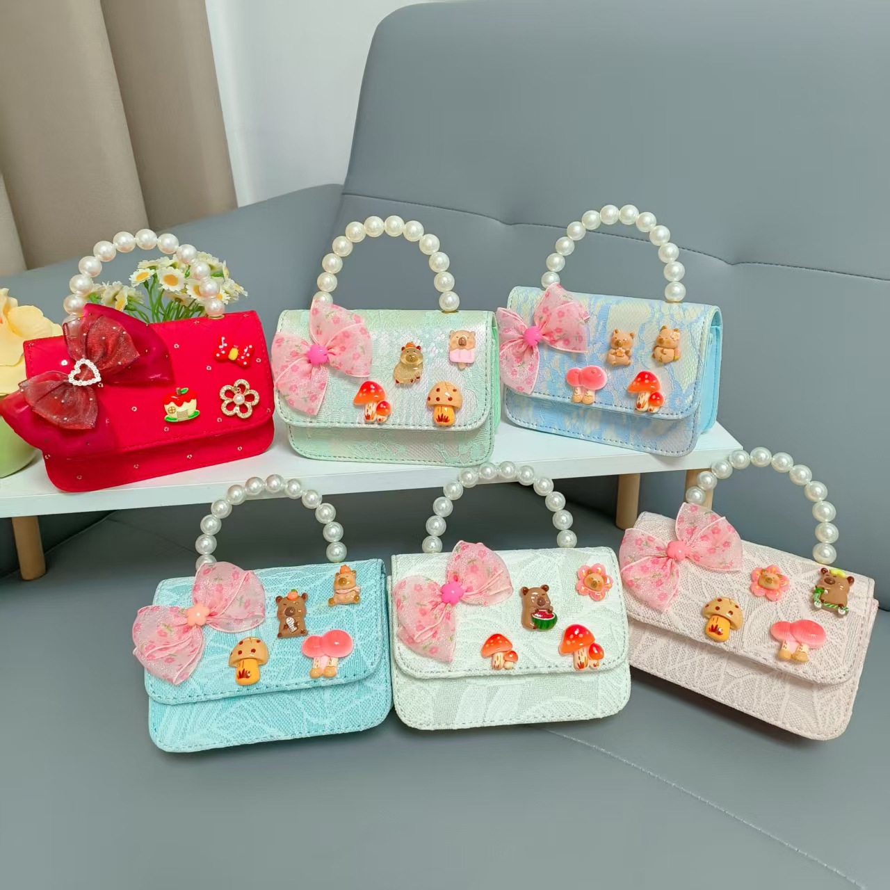 Bolsos para niños nuevos bolsos de perlas de arco para niñas bolsos de cinturón de estilo de fragancia bolsos de cadena bolsos de cambio bolsos