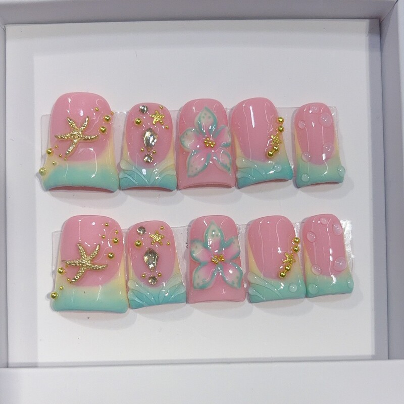 European and American style, popular beach-themed macaron press-on nails with a pink and green gradient, featuring 3D starfish and floral designs, and gold accents, in a European square shape European and American style, popular beach-themed macaron press-on nails with a pink and green gradient, featuring 3D starfish and floral designs, and gold accents, in a European square shape