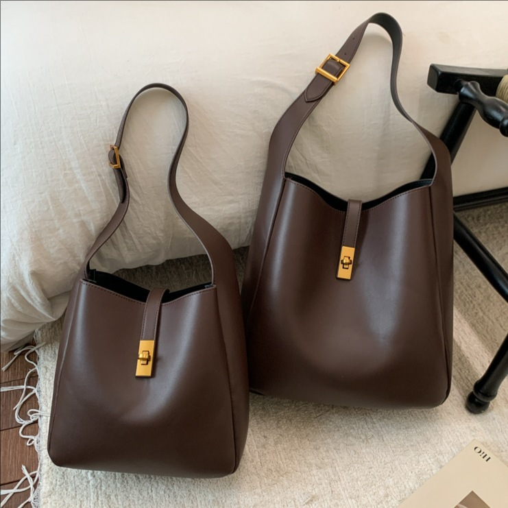 Transfronterizos de alto nivel sensación de cuero suave bolso de cubo de gran capacidad bolso de viaje para mujeres 2025 nuevo retro bolso de mochila para niños