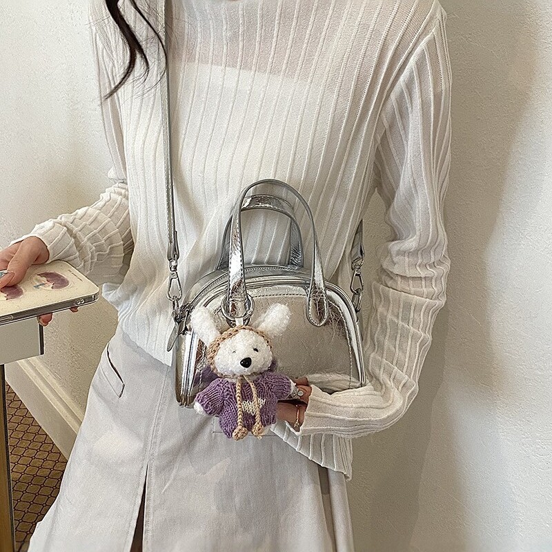 Bolsa de conchas para mujeres 2026 nuevo tipo de bolso de hombro portátil de viaje universal nicho de diseño diario bolso de mano