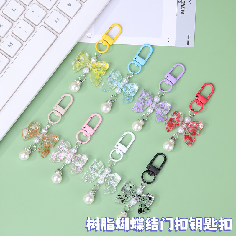 New bow-shaped candy-colored pearl pendant keychain alloy door buckle DIY bag accessory decoration