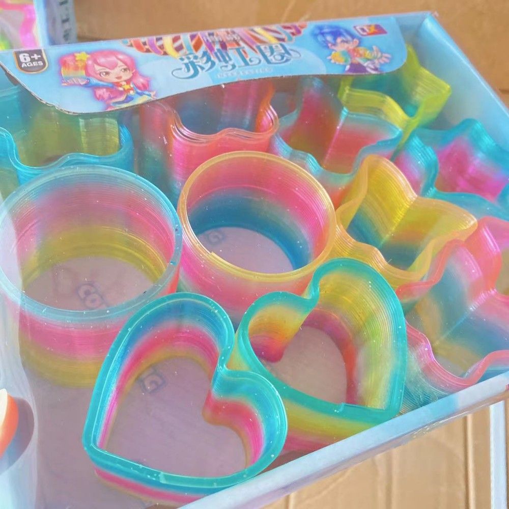 Juguete para niños anillo de arco iris elástico al por mayor primavera educativa anillo apilado gran cristal mezclado descompresión del cabello tienda departamental