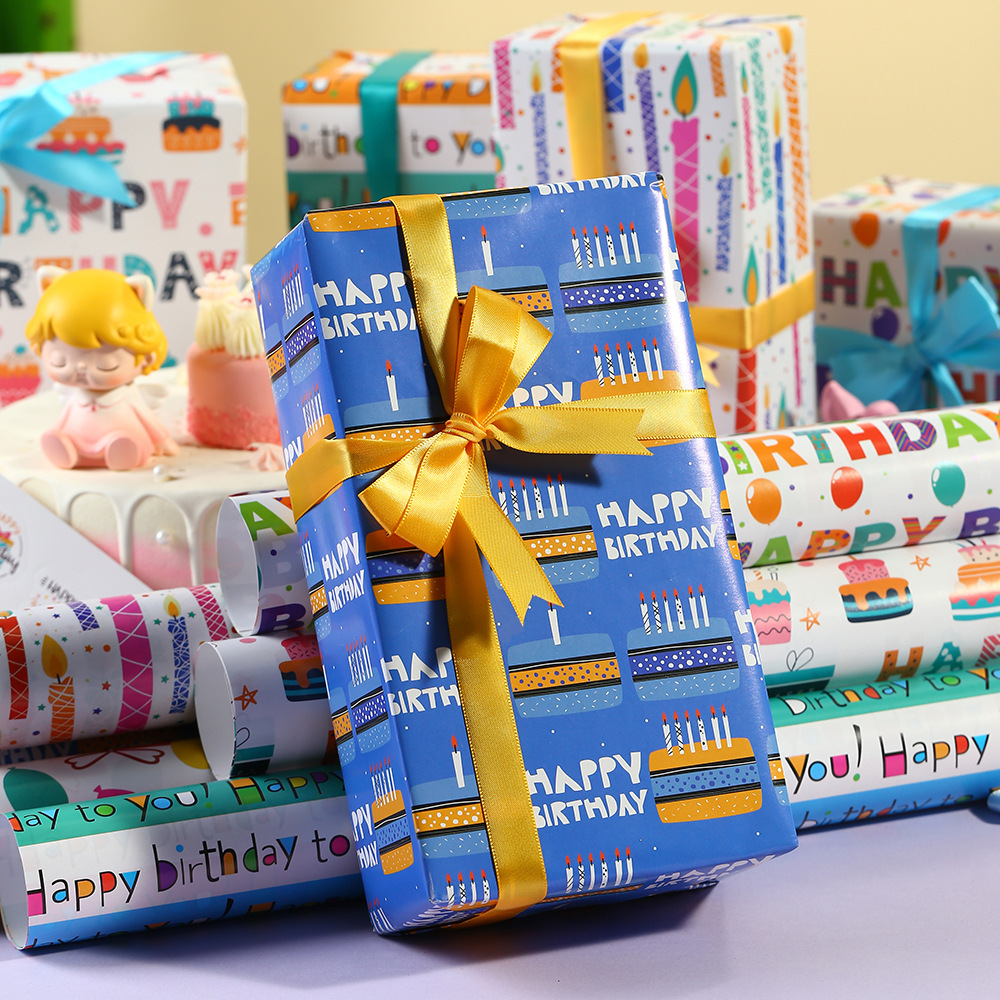 Nuevo papel recubierto creativo papel de embalaje de impresión globo de cumpleaños pastel vela papel de regalo de dibujos animados al por mayor