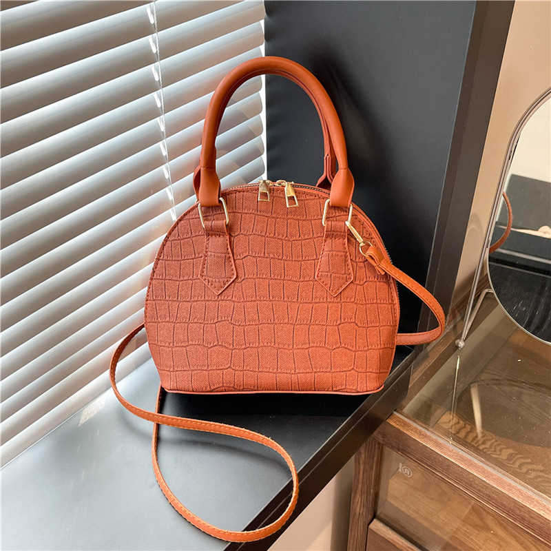 Bolso de mano de piedra para mujeres 2024 nuevo bolso de concha de textura bolso de hombro de moda minimalista estilo elegante mochila